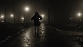 Silhouette of a woman running along a park alley at night with streetlights shining through the fog - Powered by Shutterstock - Get 15% off with code: PIKWIZARD15