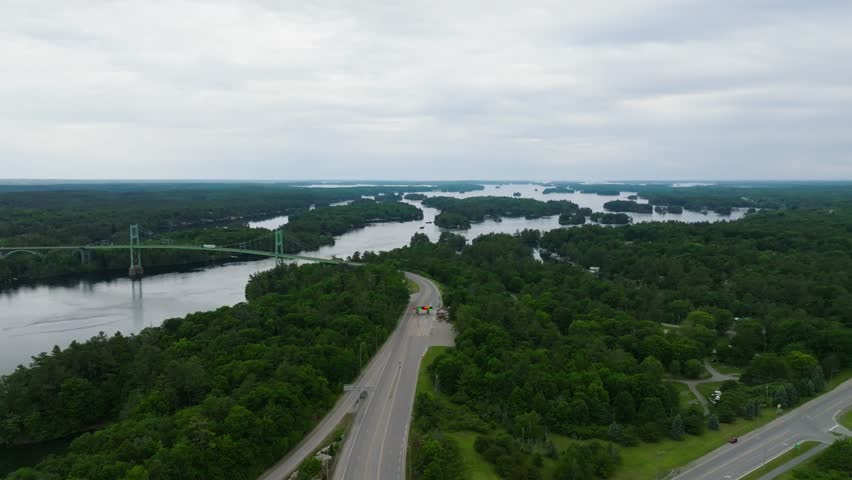 Aerial view of Thousand Islands International Bridge between Canada and US between New York State and southeastern Ontario over water and forests vehicle and pedestrian traffic crossing in summer