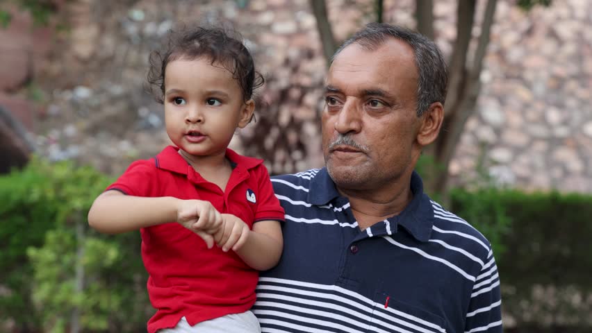 Grandfather and Grandson Bonding in Outdoor Park at Dusk