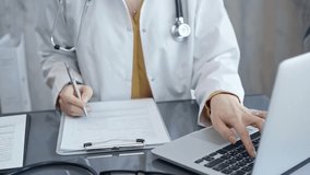 Doctor woman is working on laptop with medical reports. Healthcare professional reviews patient files and inputs data in a clinic setting. Medicine - Powered by Shutterstock - Get 15% off with code: PIKWIZARD15