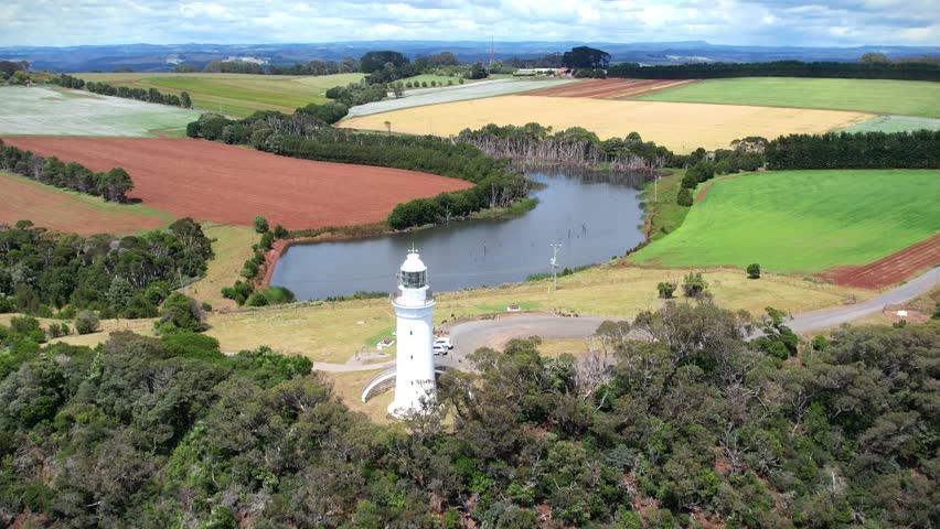 Lighthouse and colorful fields in the background in Tasmania, Australia. View from above.