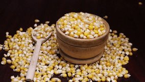Dry corn kernels for popcorn fall down into a bowl, Aerial view. Slow motion looped video for advertising. 
 - Powered by Shutterstock - Get 15% off with code: PIKWIZARD15
