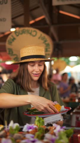 Woman Picking Appetizing Asian Food at the Local Food Market, Street Food, Travel, Summer, Asian Cuisine Concept. Chiang Mai, Thailand, Vertical Screen