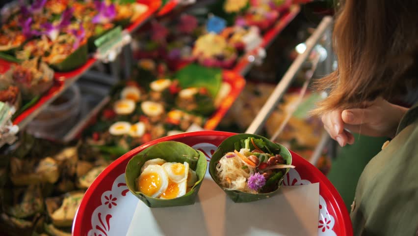 Woman Picking Appetizing Asian Food at the Local Food Market, Street Food, Travel, Summer, Asian Cuisine Concept. Chiang Mai, Thailand