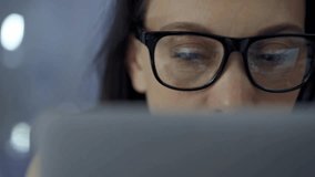 Woman with glasses engaged in reading or work, conveying concentration. Front view and close up portrait - Powered by Shutterstock - Get 15% off with code: PIKWIZARD15