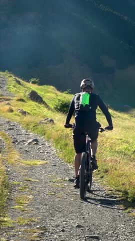 Slow motion. People cycling on mountain bikes in nature.	