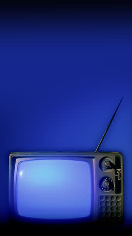A vertical view of an old fashioned 1970s television with flickering scan lines static on the screen. Copy space above.  	