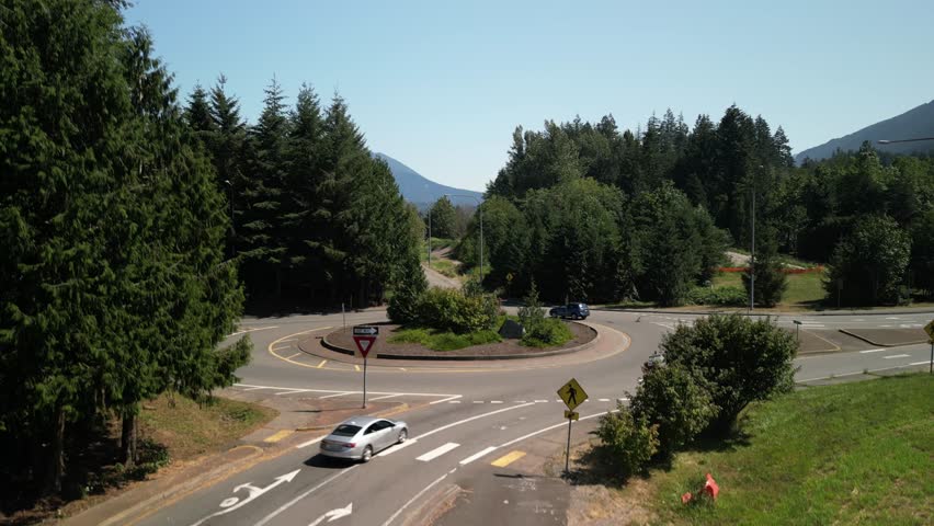 Aerial ascending above roundabout in North Bend Washington along Highway 90 in summer