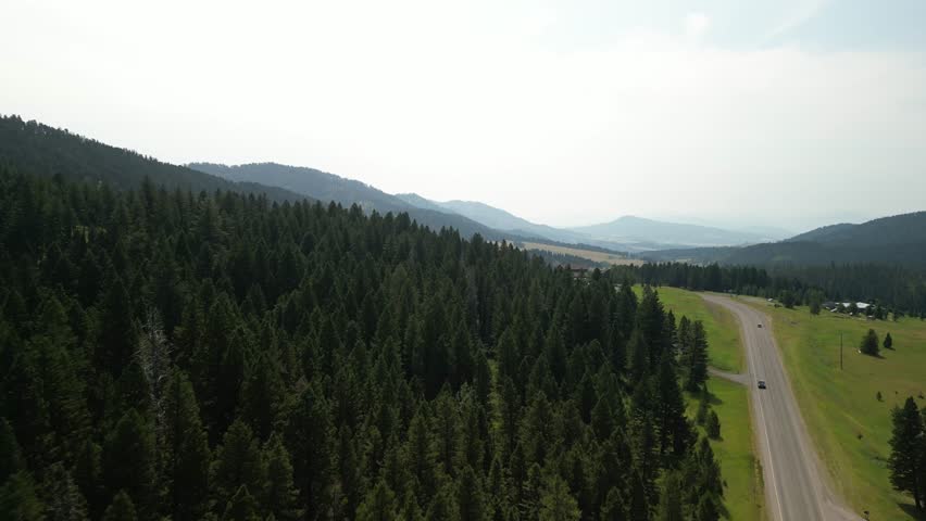 Aerial of forested highway 86 and homes in Bridger Ranger in Bozeman Montana in summer