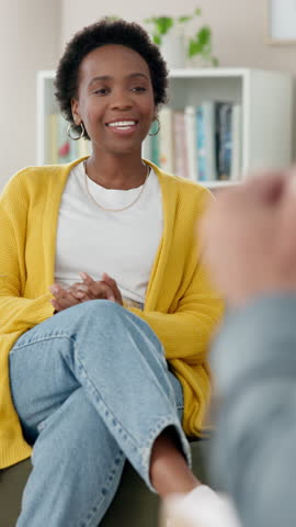 Black woman, patient and talking with psychiatrist for therapy session or appointment on sofa at clinic. Young African or female person in consultation with psychologist for health advice or help