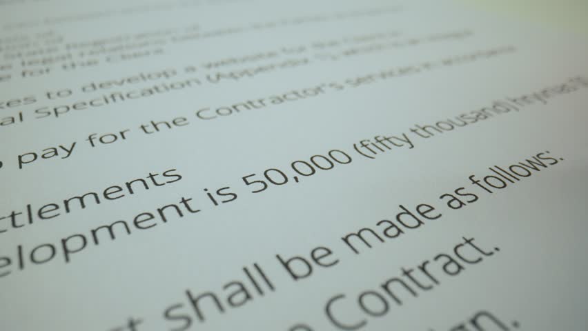 Close up shot of woman hand working with text document, liquid brush corrector in female hand draws over text, fixing the mistake.
