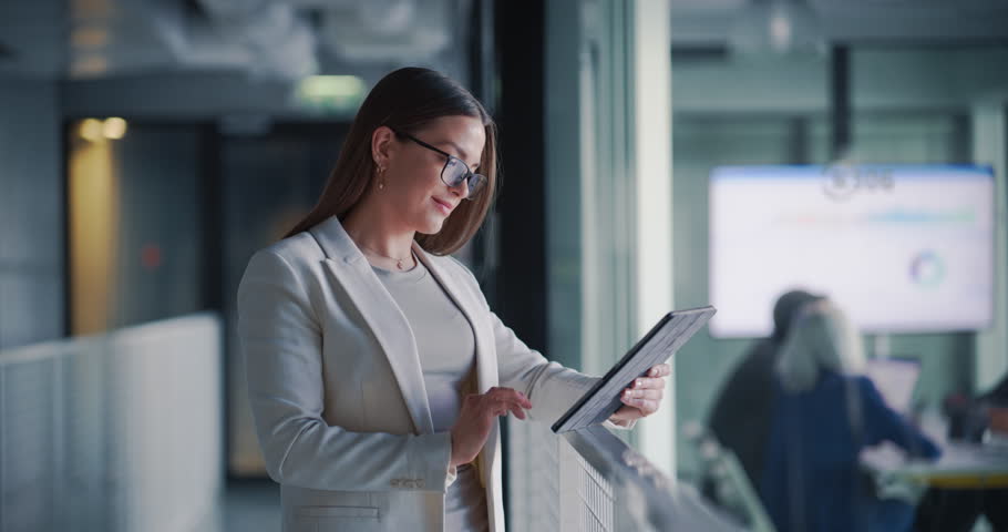 Female Professional Using Tablet Computer. Manager working with Digital Tools in the Workplace, Checking Corporate Business Accounts, Communicating with Partners and Colleagues