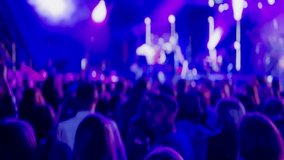 Crowd of people enjoying a live music concert with vibrant lights and colorful stage effects creating an energetic atmosphere. - Powered by Shutterstock - Get 15% off with code: PIKWIZARD15
