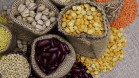 Grain cereals, various legumes, and grains in the jute bag rotating in the super shop concept. Pulses store in the market. Table spin, top view. - Powered by Shutterstock - Get 15% off with code: PIKWIZARD15