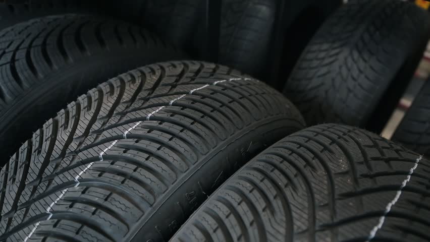 A new tire is placed on the tire storage rack in the tire shop