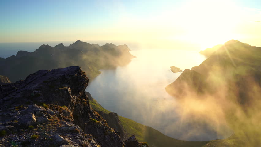 The view and the midnightsun on the summit of Keipen, Senja.