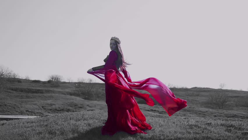  Beautiful red haired girl in metal medieval armor dress with sword standing in warlike pose