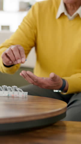 Senior man, pill box and medication for weekly dose with organizing in home for retirement. Elderly, male person and pharma for health in lounge with wellness, diabetes and treatment as pensioner