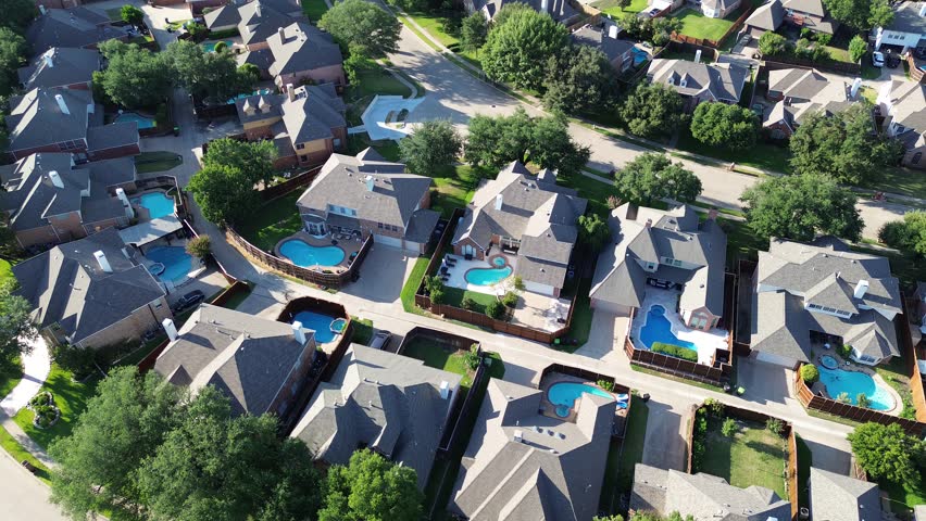 Swimming pool on almost every house at upscale residential neighborhood in Wentworth Estates, West Plano, suburbs Dallas Fort Worth metroplex, two story mansion home lush green trees, flyover. USA