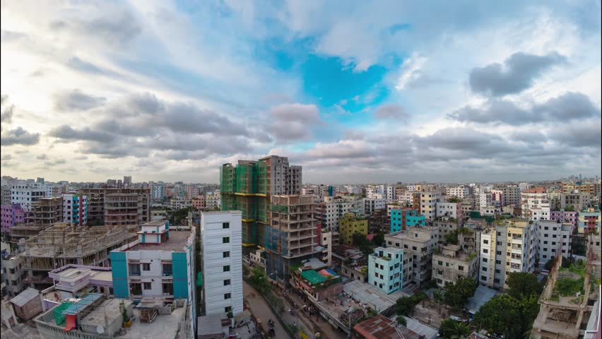 Time-Lapse Photography, clouds, a city landscape with mixed architecture, colorful buildings, busy roadway under cloudy sky, transition from day to night.