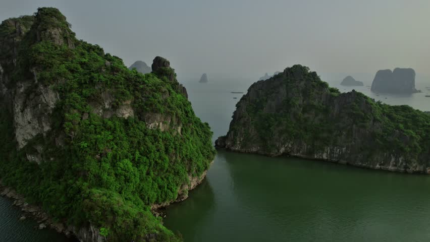 Aerial view of serene hills emerging from the water in Hạ Long Bay, Vietnam, capturing the tranquil and dramatic landscape.