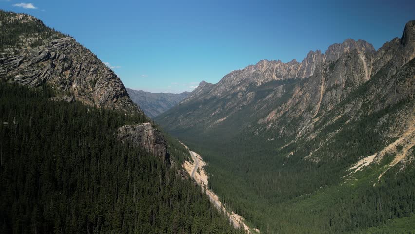 Aerial of rocky cliffs and ridge lines in North Cascades mountains near national park in summer in Washington