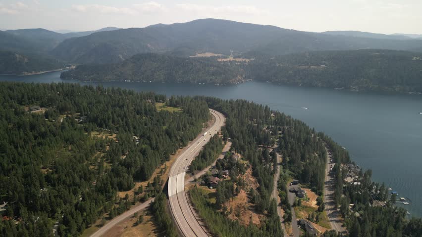 High aerial above Lake Coeur Dalene and Highway 90 in northern Idaho in summer
