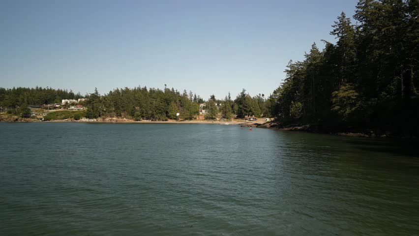 Low aerial over Pacific Ocean at Sunset Beach in Anacortes Washington