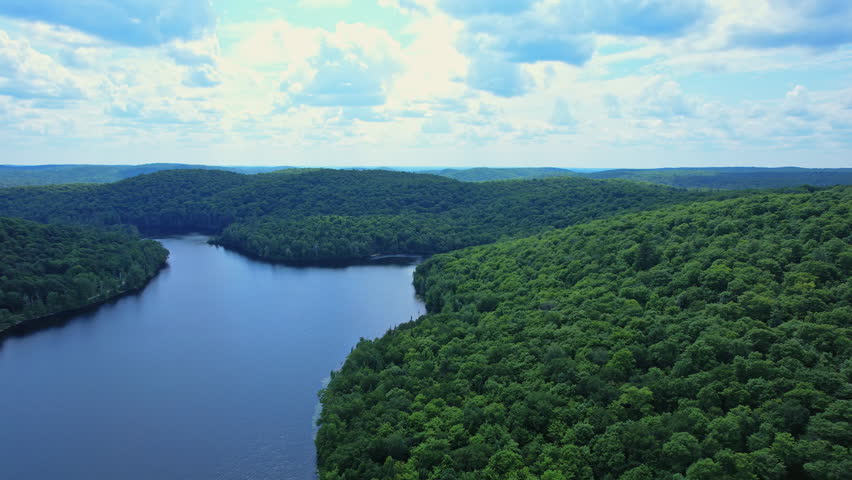Canadian vacation Bluesky lake beautiful landscape in summer sunny day with very cloudy sky. Epic panoramic water and vegetations view from above, Burk