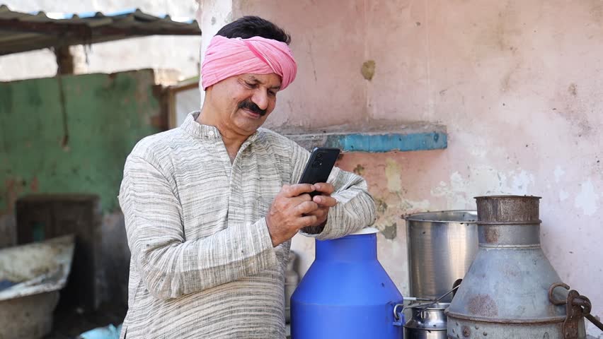Happy indian dairy farmer using smart phone, Farming industry business, Technology, Rural india,