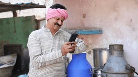 Happy indian dairy farmer using smart phone, Farming industry business, Technology, Rural india, - Powered by Shutterstock - Get 15% off with code: PIKWIZARD15
