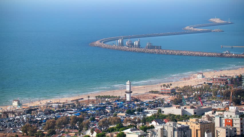 City skyline with a large body of water in the background. Ashdod in Israel. View on the beach and port. The buildings are tall and the city appears to be bustling with activity