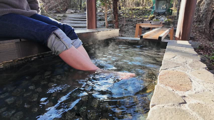 A woman taking a footbath at a hot spring resort