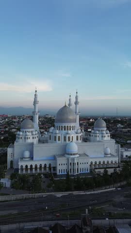This drone video showcases the stunning beauty of Sheikh Zayed Mosque in Solo from above, capturing its majestic architecture and intricate details. The cityscape in the background adds the spirituals