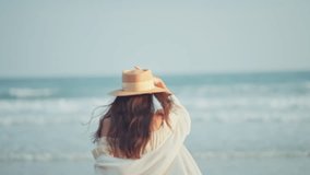 Happy Young Asian woman with straw hat walking on tropical beach, Carefree female enjoying breeze with sea in background. Travel vacation, summer outdoor pleasure. - Powered by Shutterstock - Get 15% off with code: PIKWIZARD15