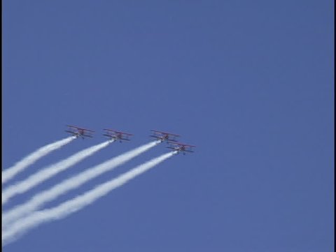 Biplanes in formation at air show - clip 1 of 2