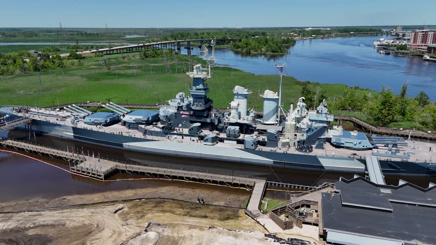 Close up aerial shot rotating around The USS North Carolina.