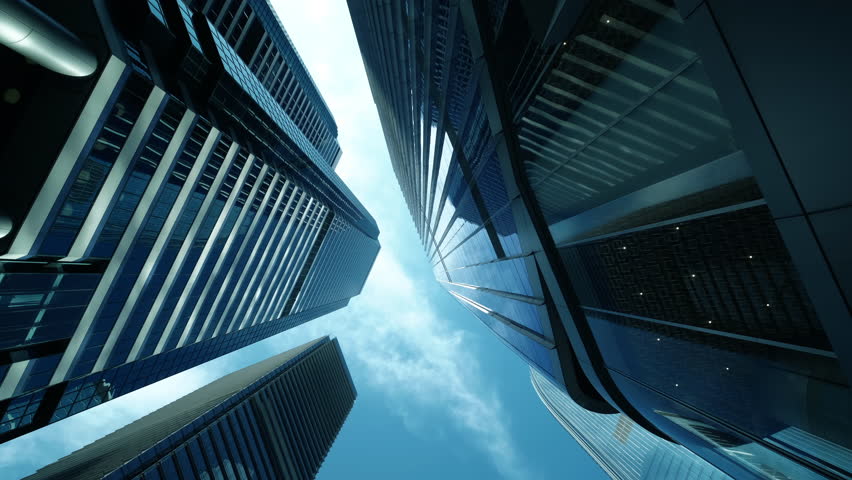 Modern business architecture with glass and steel walls reflecting sky clouds.