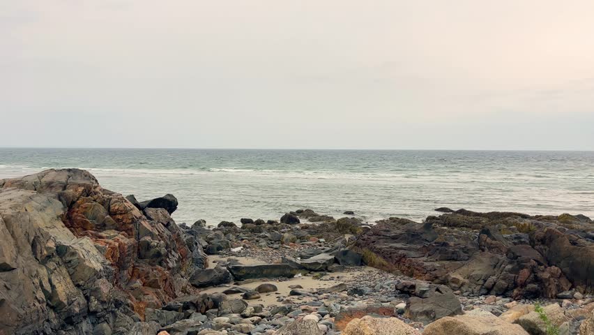 calm established seascape view of Ogunquit, Maine rocky beach at sunset US travel destination