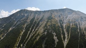 Todorka Drone Video, flying up the mountain overviewing the Western slopes. Sun is glaring from the top right corner. Pirin National park in Bulgaria. - Powered by Shutterstock - Get 15% off with code: PIKWIZARD15