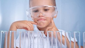 A student in a chemistry class enjoys tasting edible substances from test tubes during the lesson. This is an interesting activity that makes learning more engaging for children in school. - Powered by Shutterstock - Get 15% off with code: PIKWIZARD15