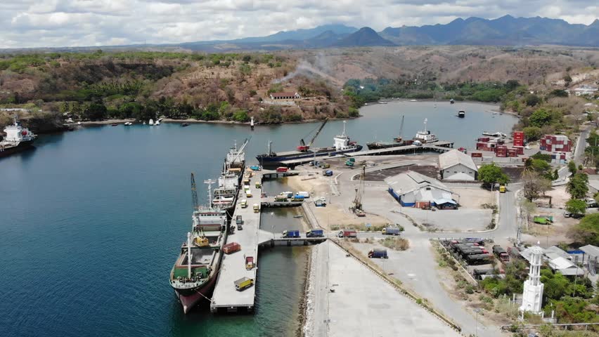 Badas Harbor on Sumbawa Island, Indonesia. loading goods at the port, drone view.