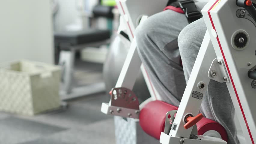 Man exercising his legs with leg extensions