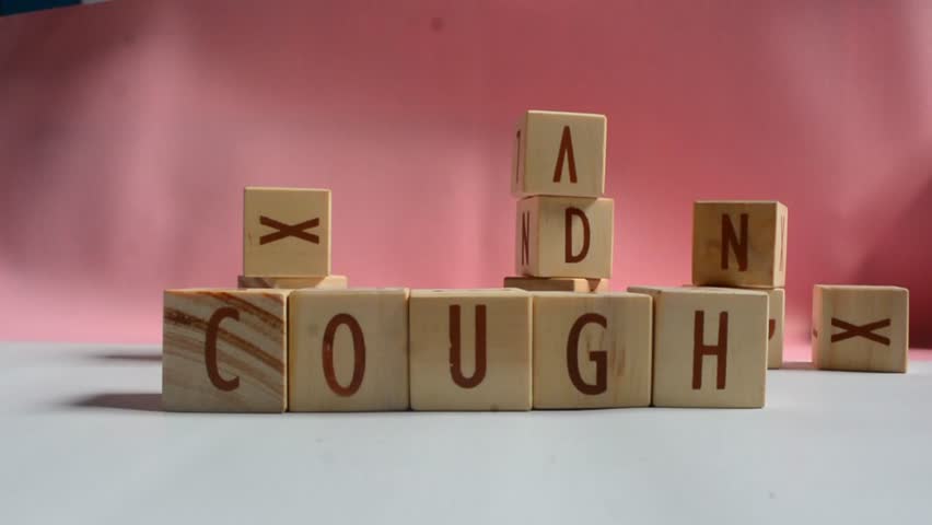 COUGH word written on wood block. Content text on wooden table for your desing, concept.