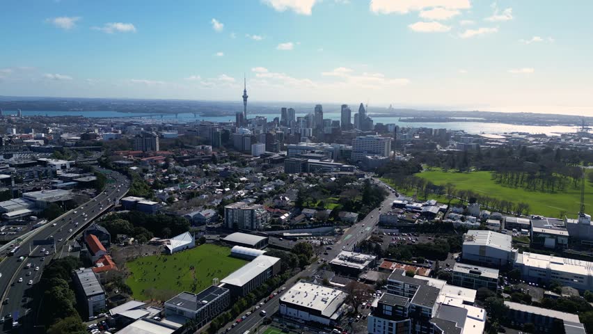 Auckland, New Zealand: Aerial drone footage of the upscale Newmarket residential district leading with the Auckland downtown skyline in the background in New Zealand largest city.  