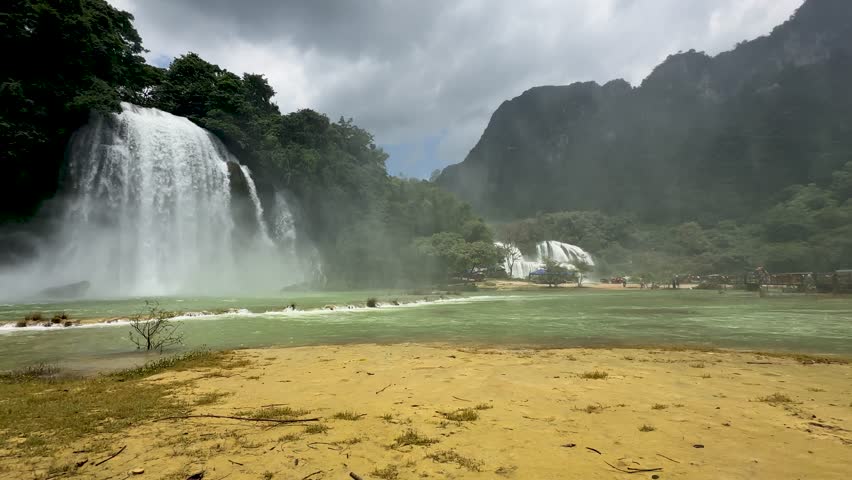 Majestic Than Ban Gioc waterfall northern Vietnam China Chinese border huge river tourist boats