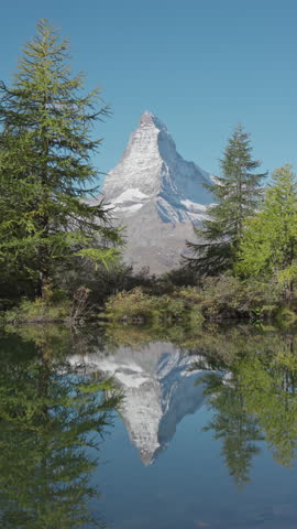 Beautiful landscape of Grindjisee Lake with Matterhorn mountain and larch forest reflection on cleary day at Zermatt, Switzerland