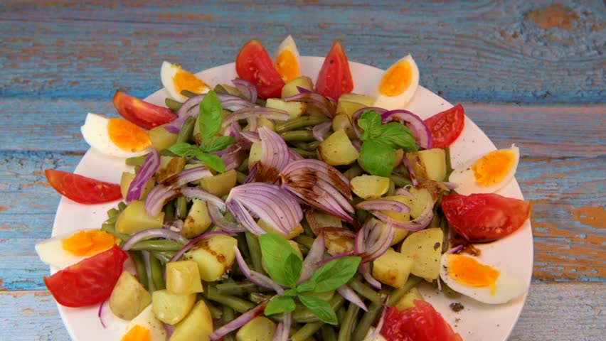 Fresh salad, green beans, small potatoes, egg, tomato, basil, red onions and balsamic vinaigrette