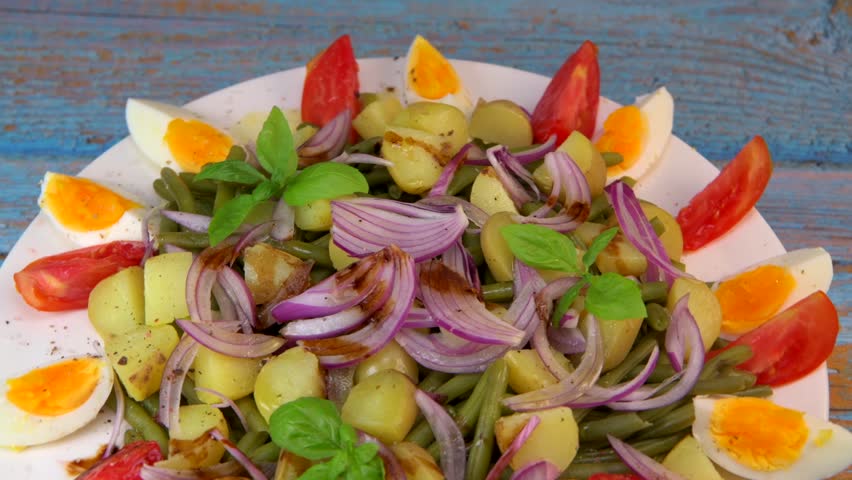 Fresh salad, green beans, small potatoes, egg, tomato, basil, red onions and balsamic vinaigrette