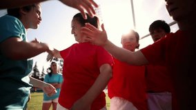 Women's soccer team members embrace and smile after a victorious match, celebrating their teamwork and success.  - Powered by Shutterstock - Get 15% off with code: PIKWIZARD15